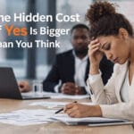 Mixed race professional woman overwhelmed at work illustrating the hidden cost of yes on focus and performance