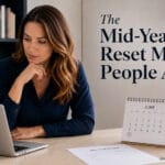 Mid-year reset blog image showing a professional reviewing progress on a laptop with a June calendar and mid-year review notes